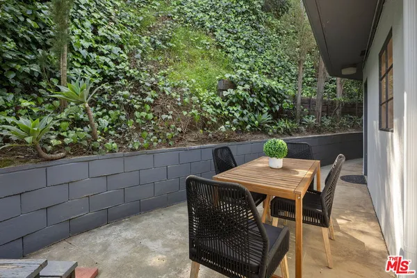 a view of a backyard with table and chairs