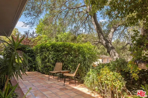 a lawn chair and table in a backyard