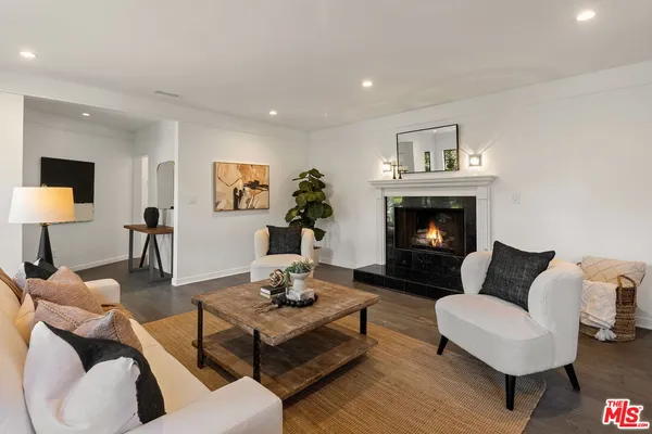 a living room with furniture fireplace and a table