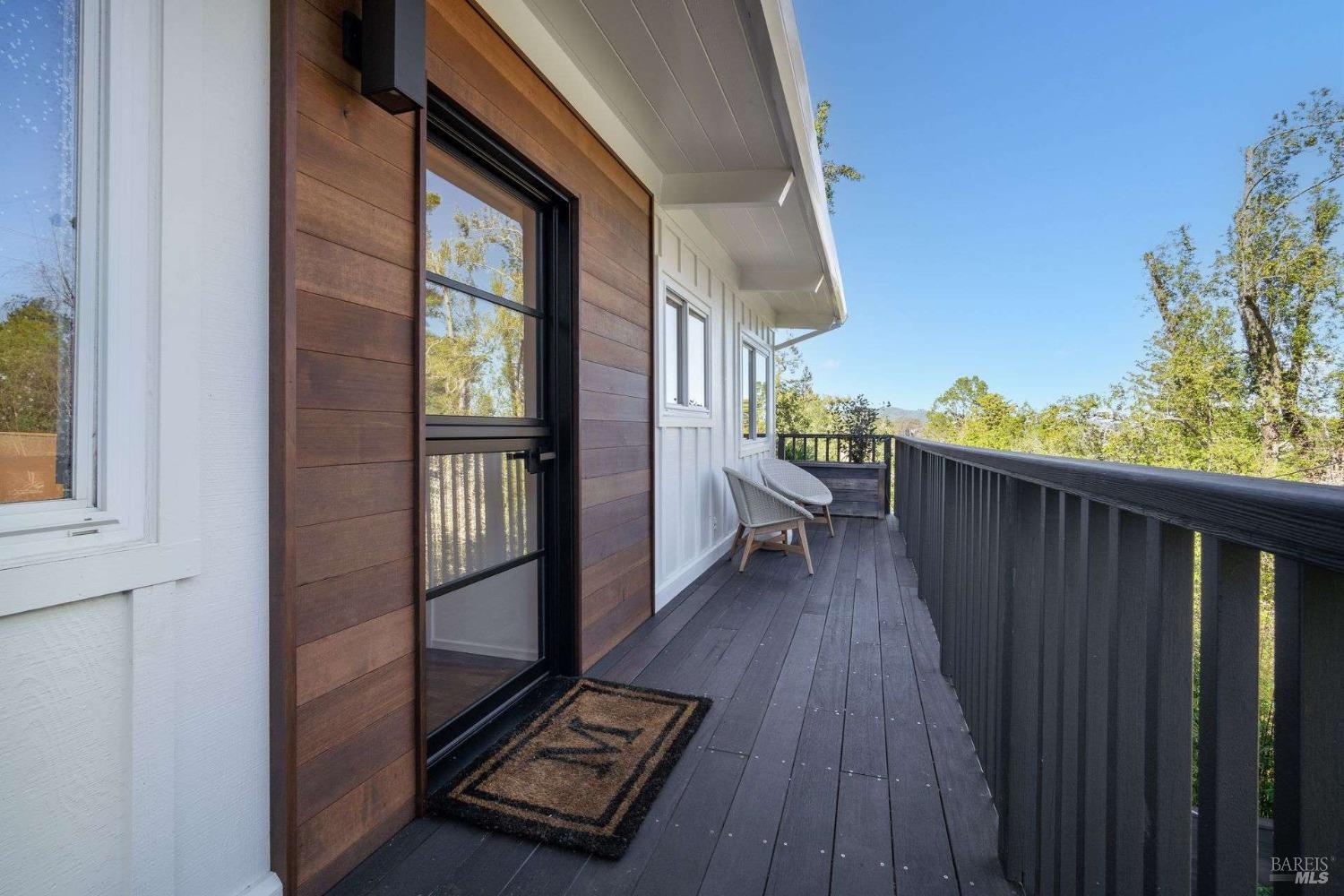 784 Marin Drive Mill Valley, CA 94941 - Photo 1 of 1 a view of a balcony with wooden floor and iron fence