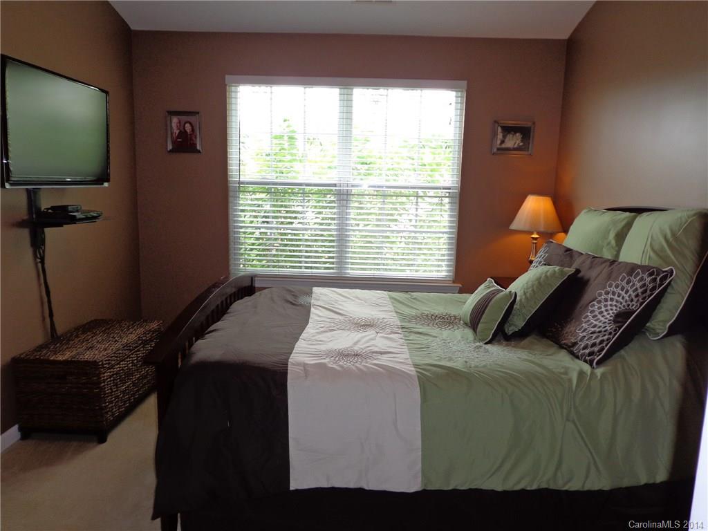 913 Copperstone Lane, Unit 188 Fort Mill, SC 29708 - Photo 15 of 24 a bed sitting in a bedroom next to a window