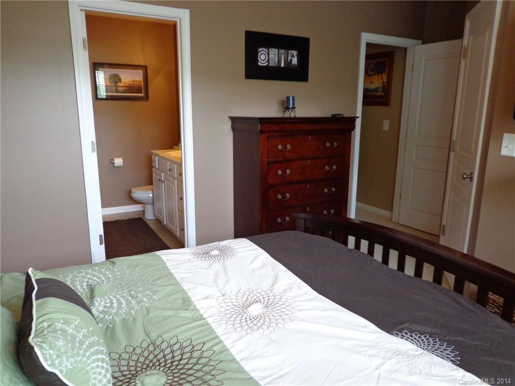 913 Copperstone Lane, Unit 188 Fort Mill, SC 29708 - Photo 18 of 24 a bedroom with a bed and a dresser