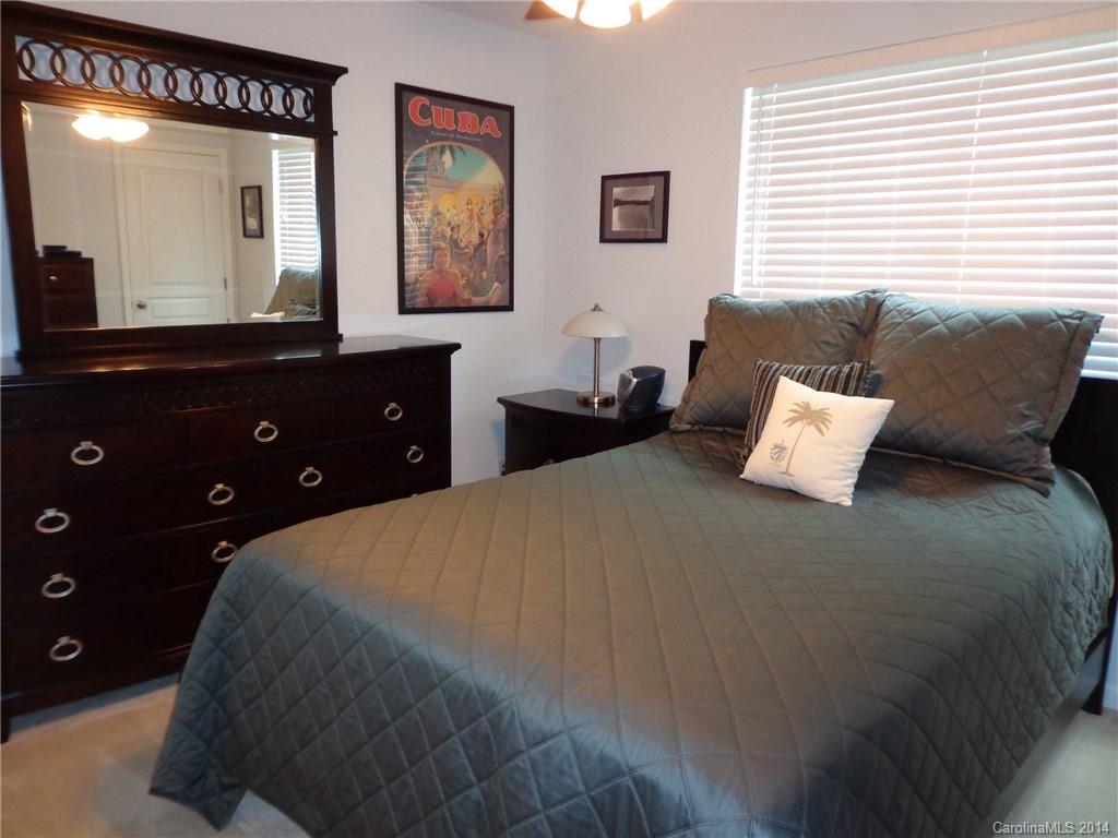 913 Copperstone Lane, Unit 188 Fort Mill, SC 29708 - Photo 21 of 24 a bedroom with a bed and painting on the wall