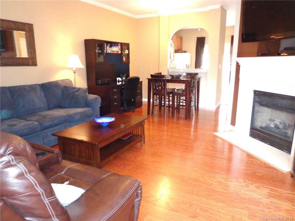 913 Copperstone Lane, Unit 188 Fort Mill, SC 29708 - Photo 5 of 24 a living room with furniture a dining table and wooden floor