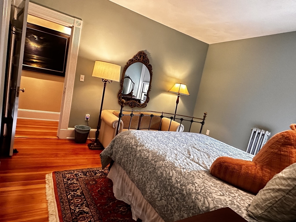 24 Beaufort Road, Unit 3 Boston, MA 02130 - Photo 13 of 25 a bedroom with a bed and wooden floor