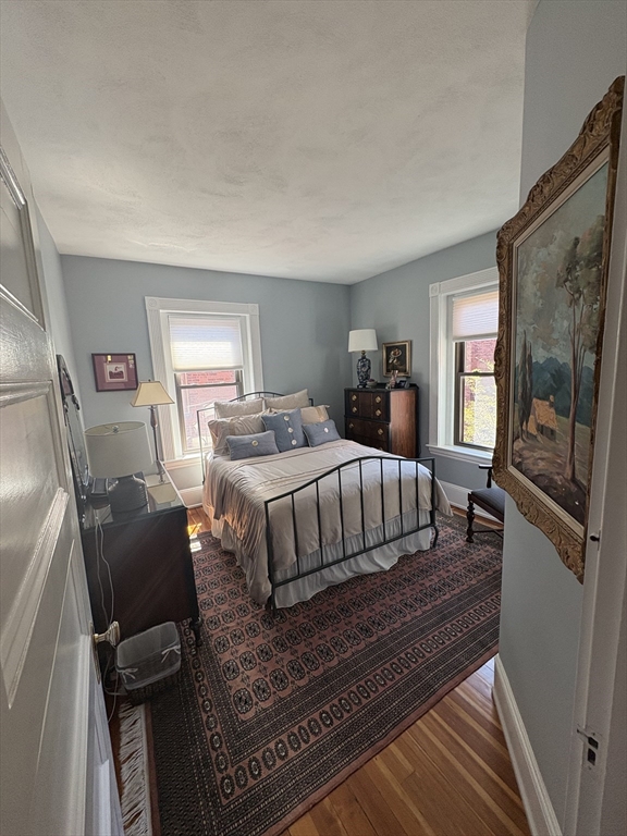24 Beaufort Road, Unit 3 Boston, MA 02130 - Photo 23 of 32 a bedroom with a bed wooden floor and window