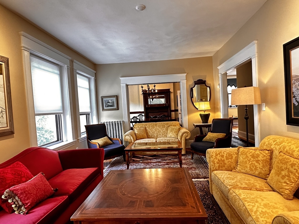 24 Beaufort Road, Unit 3 Boston, MA 02130 - Photo 4 of 32 a living room with furniture floor to ceiling window and a flat screen tv