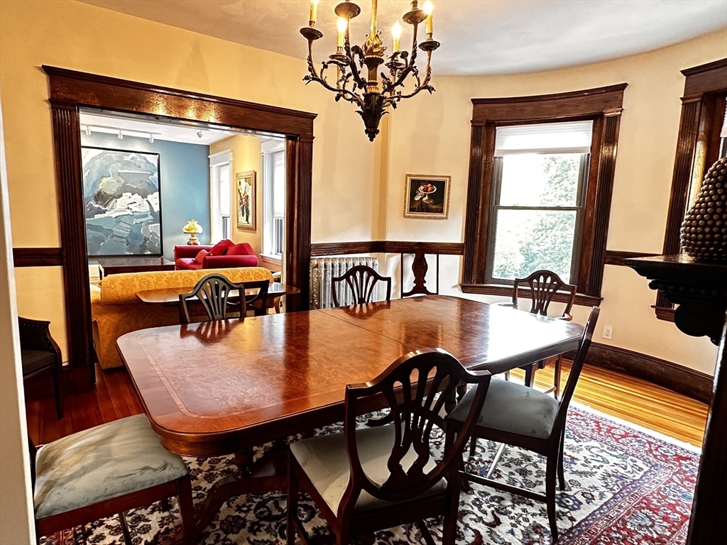 24 Beaufort Road, Unit 3 Boston, MA 02130 - Photo 9 of 25 a dining room with furniture a chandelier and wooden floor