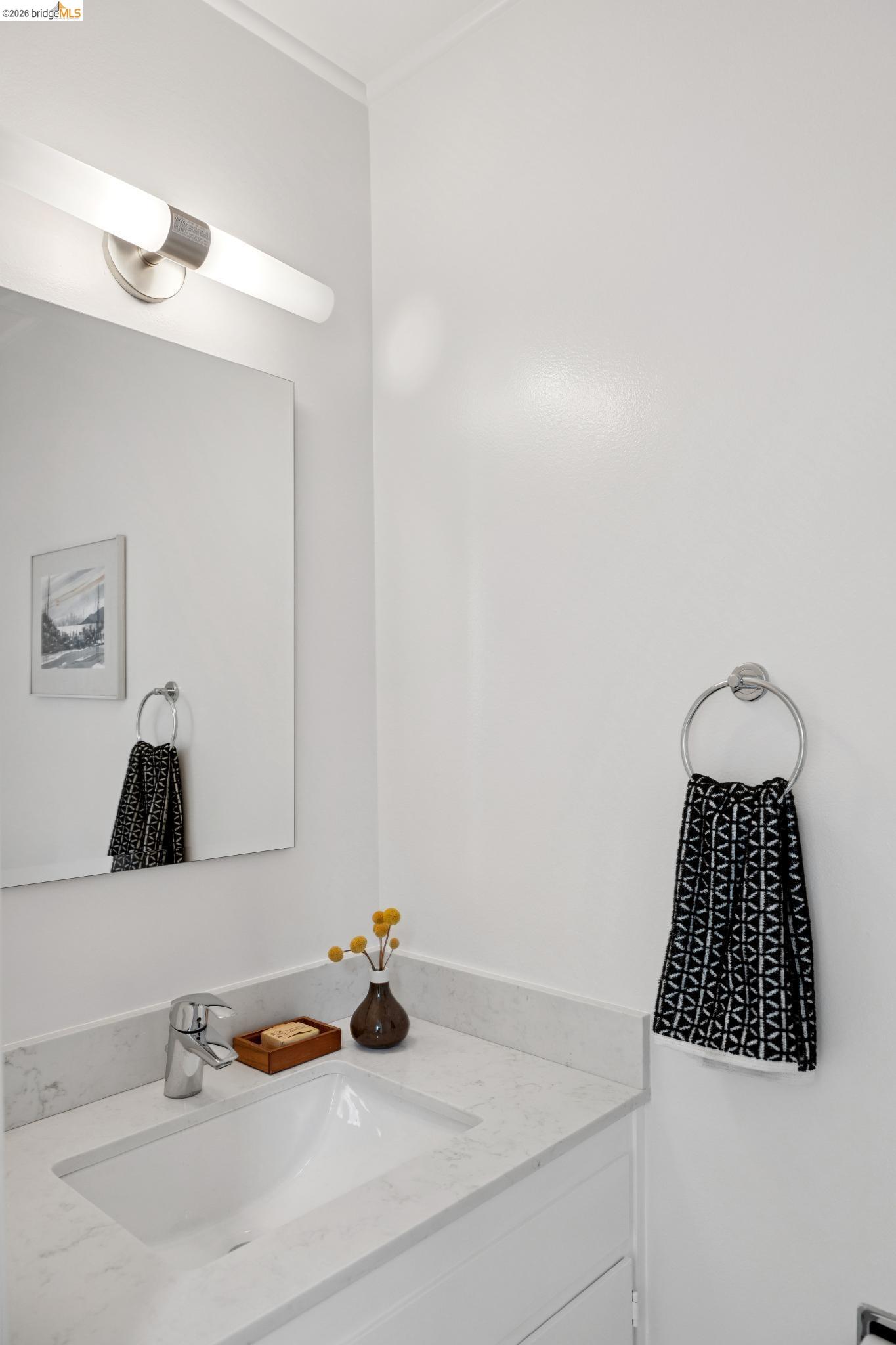 1340 Henry Street Berkeley, CA 94709 - Photo 32 of 52 Vanity with an integrated rectangular sink, a stone-finish countertop, and a chrome single-handle faucet