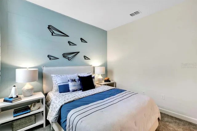 a bedroom with a bed and a night stand