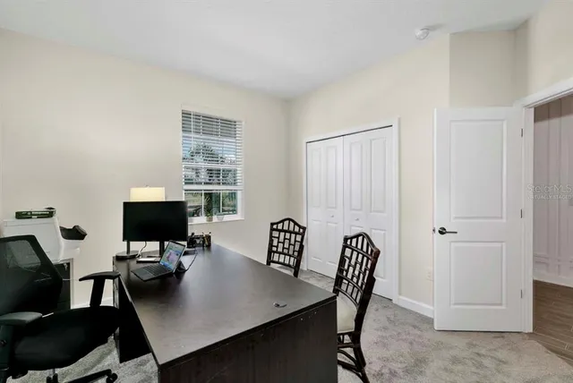 a view of a workspace with a table and chairs