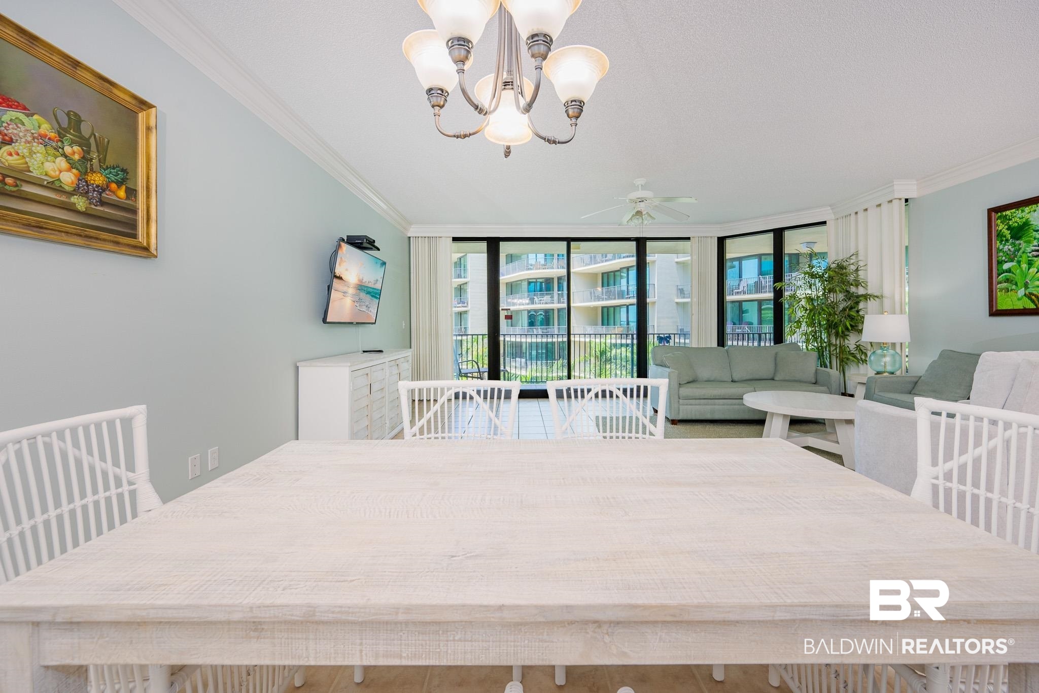 27580 Canal Road, Unit 1322 Orange Beach, AL 36561 - Photo 6 of 30 Dining space with crown molding, ceiling fan, a chandelier, and a wall of windows
