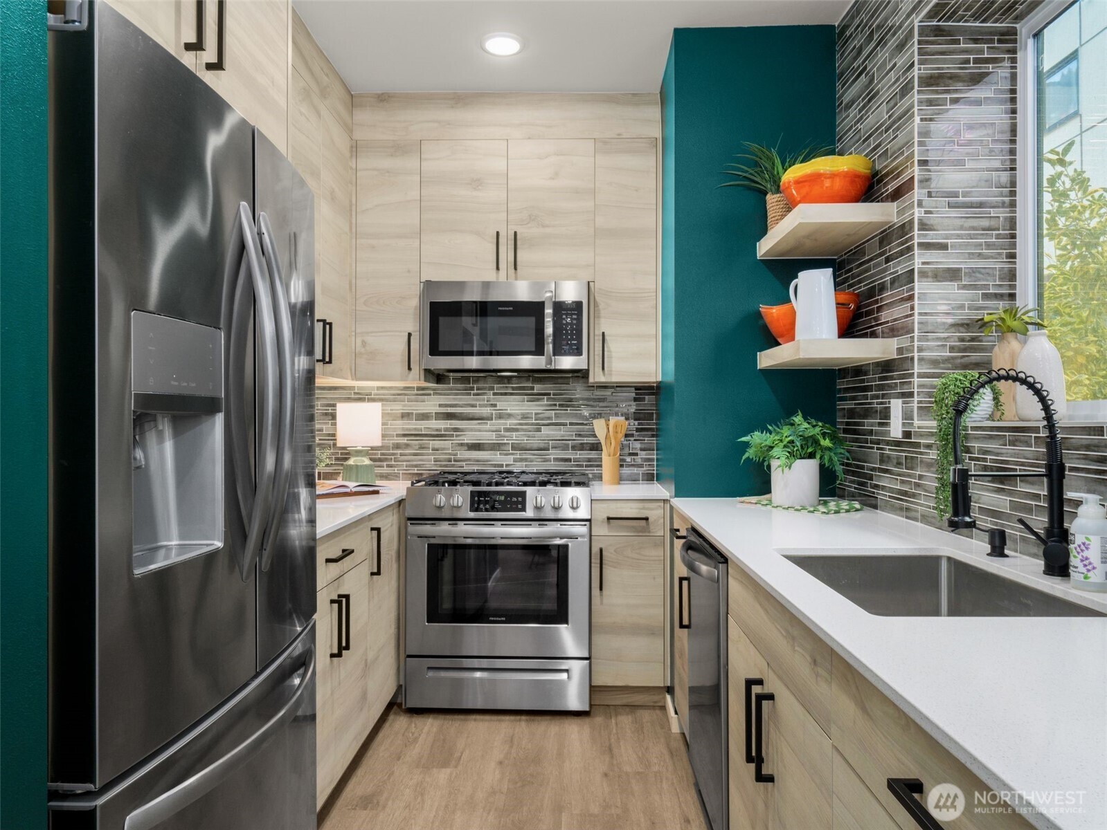 541 South Cloverdale Street, Unit B Seattle, WA 98108 - Photo 11 of 29 a kitchen with stainless steel appliances a stove a sink and a refrigerator