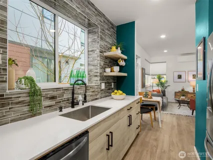 a kitchen with a sink appliances and cabinets
