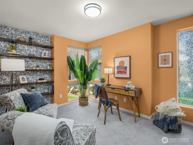a living room with furniture and a potted plant
