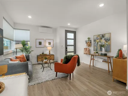 a living room with furniture and a wooden floor