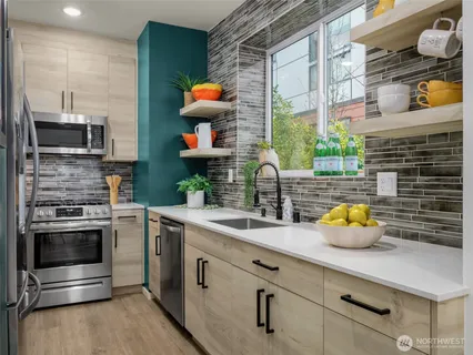 a kitchen with a sink and a stove top oven