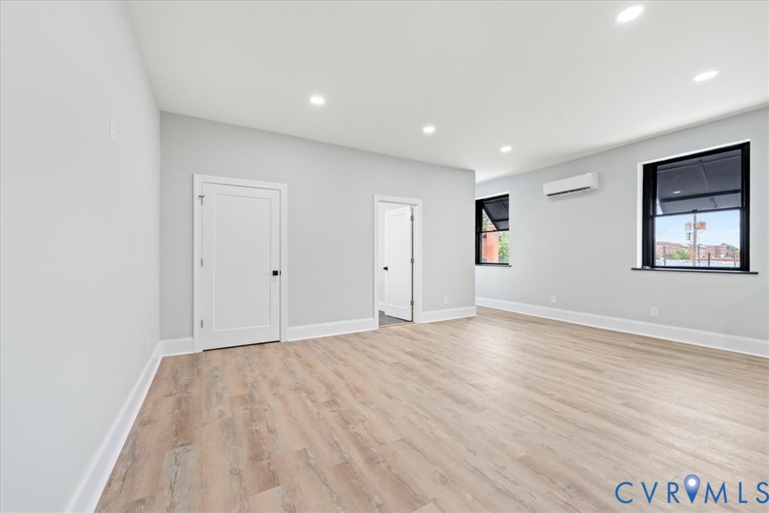 207 East Broadway, Unit B Hopewell, VA 23860 - Photo 11 of 27 a view of empty room with wooden floor and fan