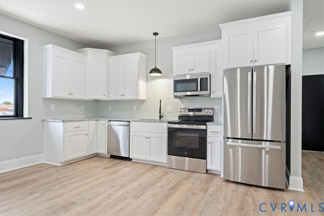 207 East Broadway, Unit B Hopewell, VA 23860 - Photo 15 of 27 a kitchen with granite countertop stainless steel appliances a refrigerator and a stove top oven