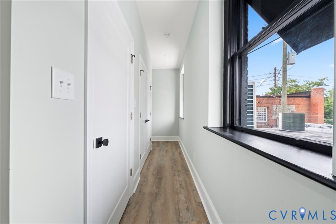 207 East Broadway, Unit B Hopewell, VA 23860 - Photo 17 of 27 a view of a hallway with wooden floor and staircase