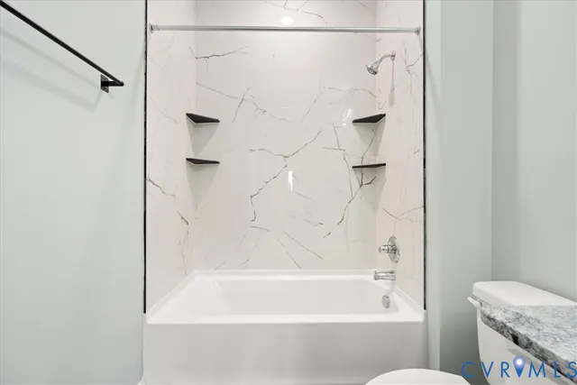 a bathroom with a shower and a bath tub