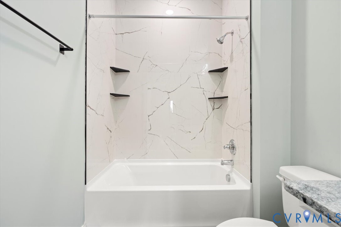 207 East Broadway, Unit B Hopewell, VA 23860 - Photo 4 of 27 a bathroom with a shower and a bath tub