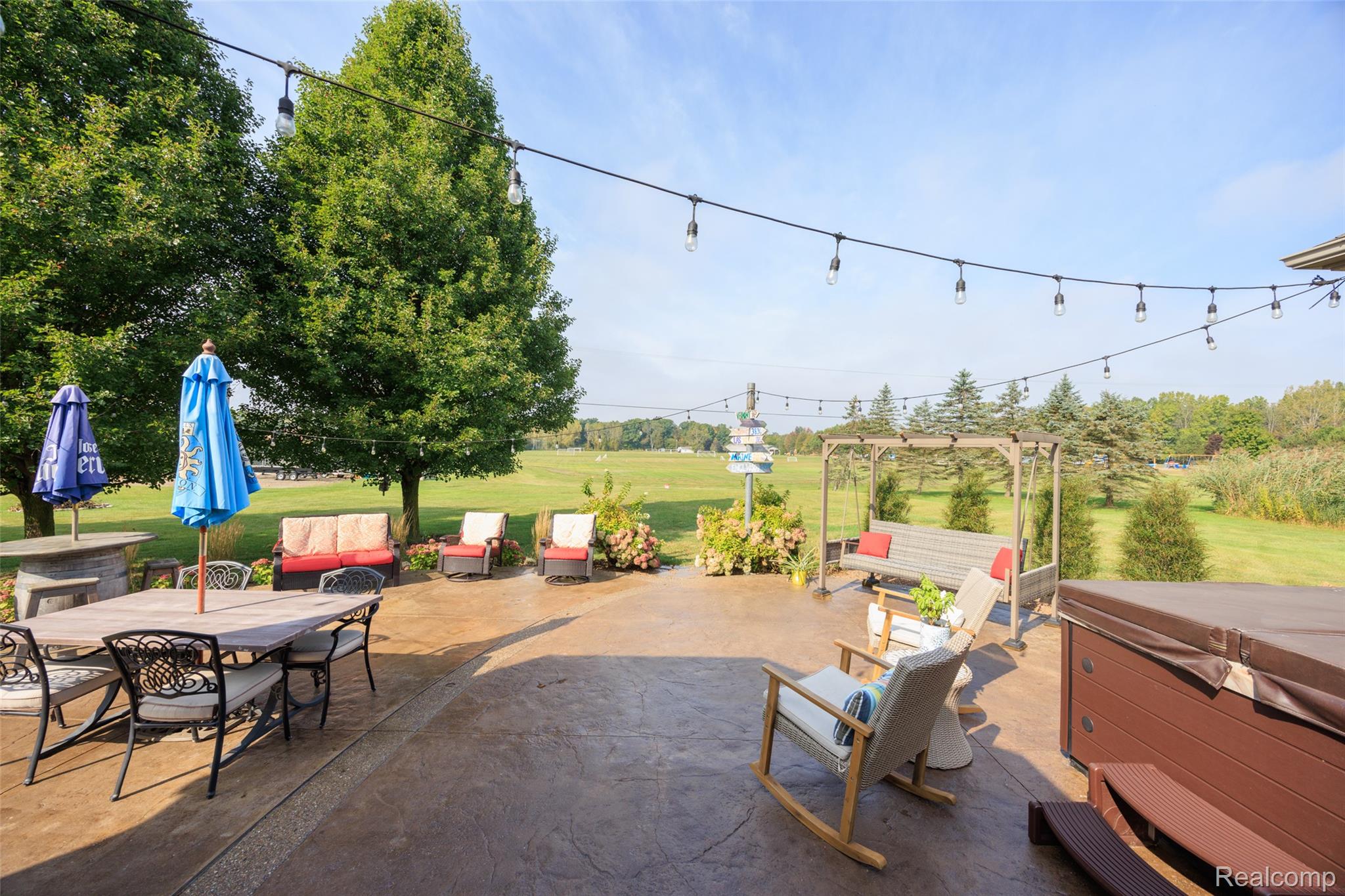 7030 Marsh Road Marine City, MI 48039 - Photo 38 of 47 View of patio with outdoor dining space, a hot tub, and a pergola