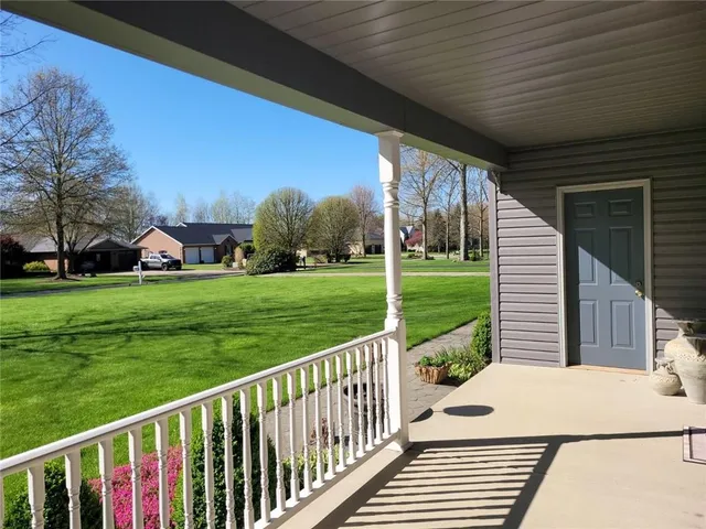 a view of a wooden deck and a yard