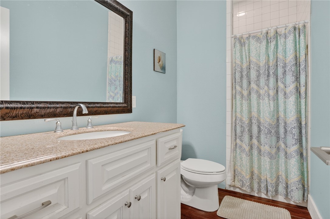 838 Rattlesnake Point Road Rockport, TX 78382 - Photo 28 of 40 a bathroom with a toilet a sink and a mirror