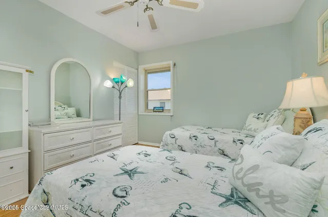 a bedroom with a bed and a mirror on dresser