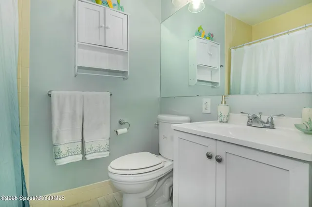 a bathroom with a sink toilet and vanity