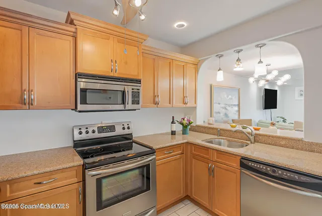 a kitchen with a sink stove and microwave
