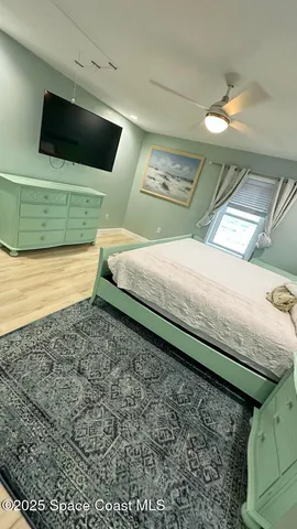 a bedroom with a bed and a television