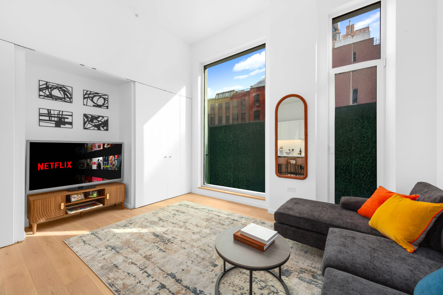 330 Grand Street, Unit 1B Manhattan, NY 10002 - Photo 2 of 14 a living room with furniture and a flat screen tv