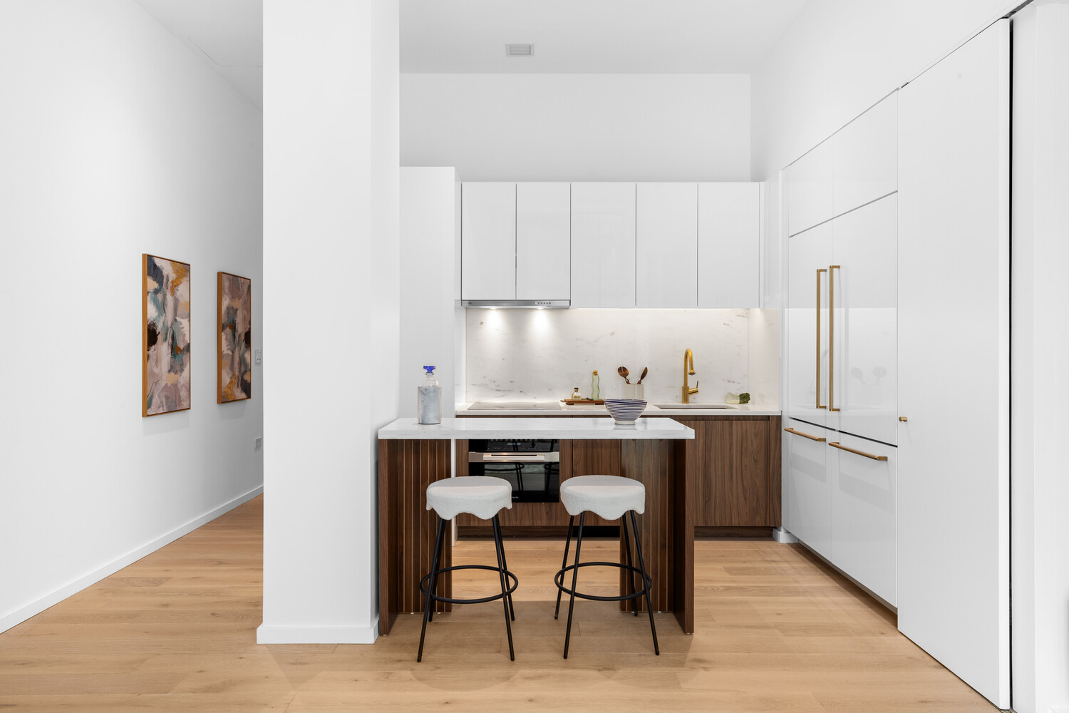 330 Grand Street, Unit 1B Manhattan, NY 10002 - Photo 3 of 14 a room with stainless steel appliances kitchen island granite countertop a table chairs sink and cabinets