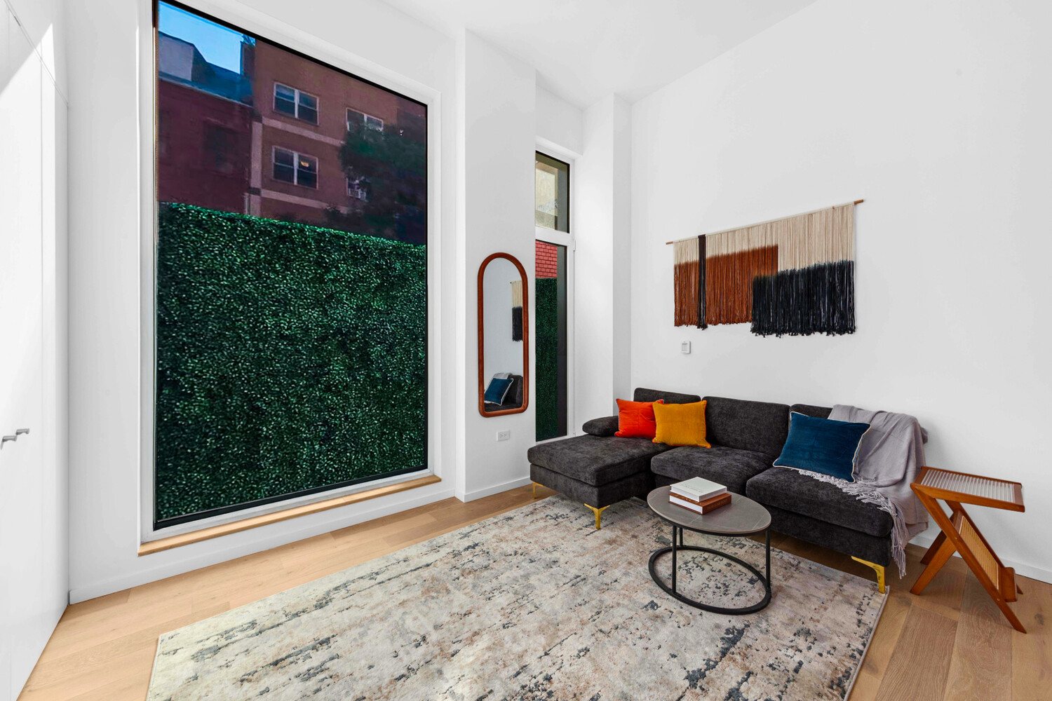 330 Grand Street, Unit 1B Manhattan, NY 10002 - Photo 4 of 14 a living room with furniture and a flat screen tv