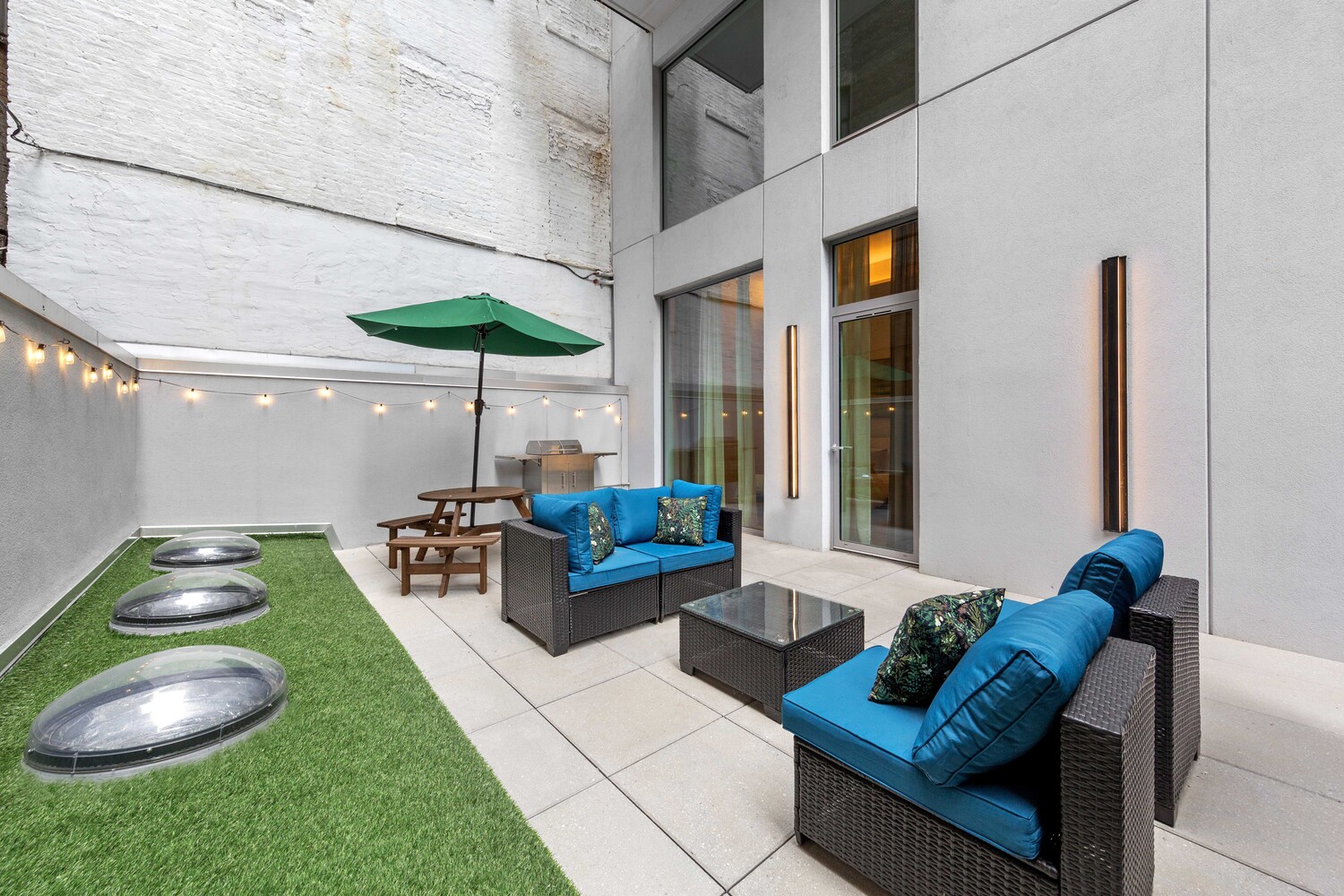 330 Grand Street, Unit 1B Manhattan, NY 10002 - Photo 7 of 14 a patio with couches and a potted plant