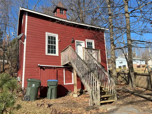front view of a house with a bench
