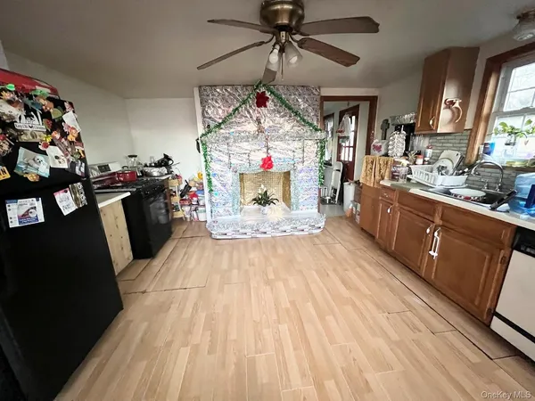 a living room with stainless steel appliances kitchen island granite countertop furniture a rug and a fireplace