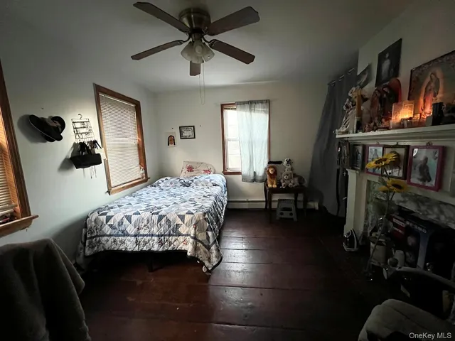 a bedroom with a bed a flat screen tv and dresser