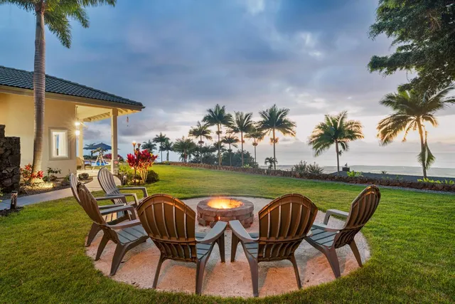 a view of a swimming pool and lounge chairs in patio