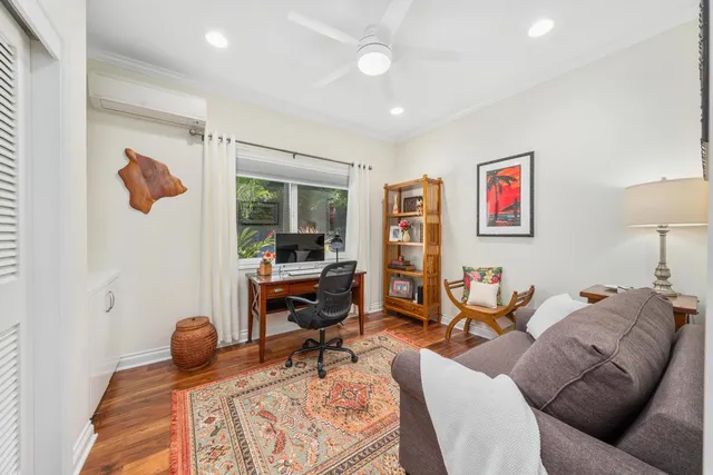 a living room with furniture a rug and a flat screen tv