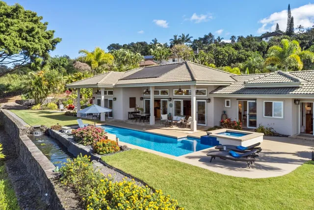 a view of a house with swimming pool and sitting area