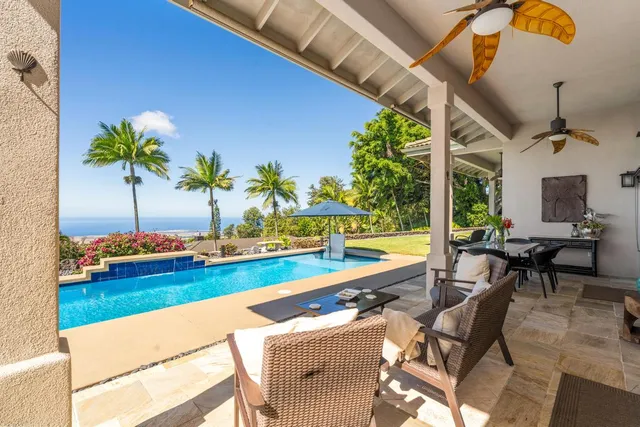a view of swimming pool with outdoor seating and a potted plant
