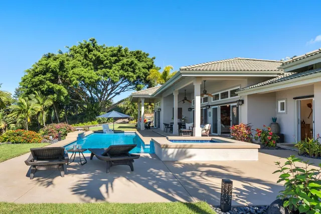 a view of a patio with table and chairs potted plants and large tree