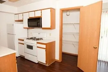 a kitchen with a stove microwave and sink