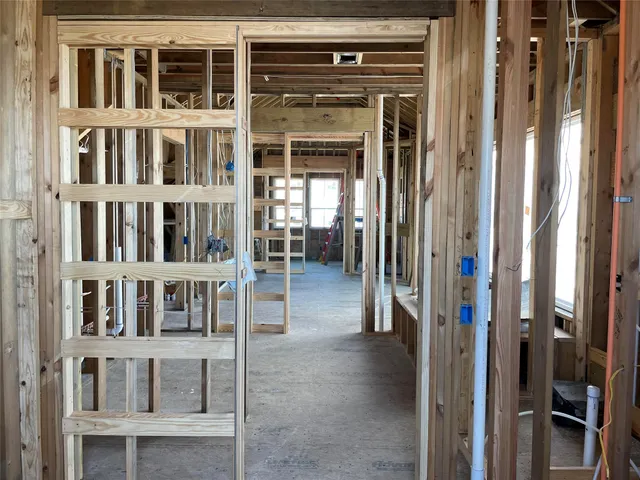 a view of staircase with white door and windows
