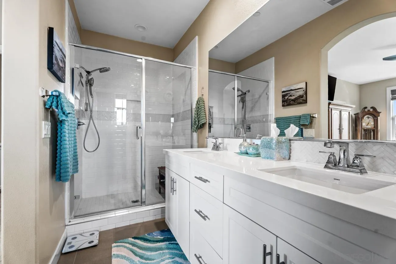 4326 Star Path Way, Unit 1 Oceanside, CA 92056 - Photo 30 of 46 a bathroom with a shower sink and mirror