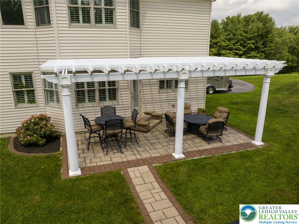 217 Gower Road Nazareth, PA 18064 - Photo 7 of 44 An inviting outdoor patio, featuring a pergola and ample space for entertaining, extends from the home's rear.