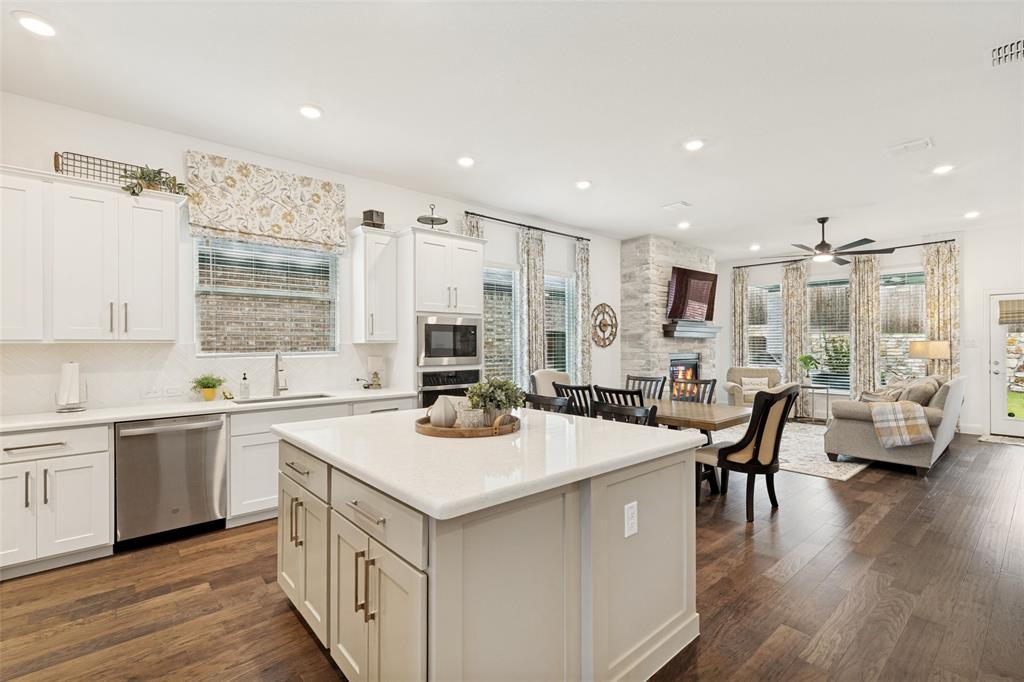 229 Savannah Lane Oak Point, TX 75068 - Photo 5 of 26 a kitchen with a white cabinets and chairs